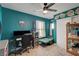 Bedroom with teal walls, ceiling fan, and built-in workspace at 207 W Victory Rd, Henderson, NV 89015