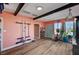 Bright living room with exposed beams, hardwood floors and coral walls at 207 W Victory Rd, Henderson, NV 89015