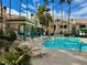 Community pool with covered patio and lounge chairs at 2251 Wigwam Pkwy # 716, Henderson, NV 89074