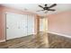 Bedroom with pink walls, wood-look floors and large closet at 2337 Ivory Point Ct, Las Vegas, NV 89134