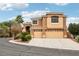 Two-story house with tan exterior, three-car garage, and landscaped front yard at 2337 Ivory Point Ct, Las Vegas, NV 89134