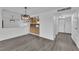 Open dining area with modern light fixture and kitchen access at 2443 El Paseo Cir, Las Vegas, NV 89121