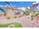 Landscaped backyard with gravel, grass, and a built-in grill at 2813 Vista Butte Dr, Las Vegas, NV 89134