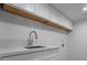 Laundry room with white cabinets and stainless steel sink at 303 Vallarte Dr, Henderson, NV 89014