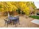 Backyard patio with a metal table and chairs under trees at 3620 E Chablis, Pahrump, NV 89048