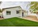 Covered patio and artificial turf backyard with white pergola at 3718 White Angel Dr, North Las Vegas, NV 89032