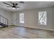 Living room features laminate floors, a modern staircase, and two windows at 3919 Visby Ln # 0, Las Vegas, NV 89119