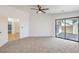 Bright bedroom with carpet flooring, ceiling fan, and sliding glass door to patio at 413 Mulberry Glen Dr, North Las Vegas, NV 89031