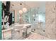 Spa-like bathroom with marble finishes, glass shower, and soaking tub at 4381 W Flamingo Rd # 3012, Las Vegas, NV 89103