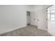 Bright bedroom with grey carpet and an adjacent closet at 4623 Harvest Night St, Las Vegas, NV 89129