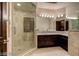 Bathroom with walk-in shower, granite vanity, and dark wood cabinets at 4927 Spanish Heights Dr, Las Vegas, NV 89148