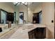 Elegant bathroom with corner sink and dark wood cabinets at 4927 Spanish Heights Dr, Las Vegas, NV 89148