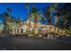 Luxury home with palm trees and landscaped grounds at night at 4927 Spanish Heights Dr, Las Vegas, NV 89148