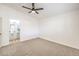 Well-lit bedroom with ceiling fan and access to bathroom at 5186 Jewel Canyon Dr, Las Vegas, NV 89122