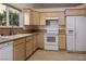 Galley kitchen with light wood cabinets and white appliances at 553 Eagle St, Mesquite, NV 89027