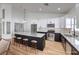 Modern kitchen featuring white and dark cabinetry, and an island with seating at 5604 Island Breeze Ct, Las Vegas, NV 89130