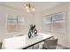 Elegant dining room with a marble table and modern light fixture at 6004 Rampolla Dr, Las Vegas, NV 89141