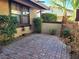 Small brick courtyard with potted plants and shrubs at 6411 Sandpiper Way, Las Vegas, NV 89103