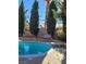 Refreshing blue swimming pool with diving board and surrounding patio at 6411 Sandpiper Way, Las Vegas, NV 89103