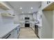 Modern kitchen featuring gray shaker cabinets, stainless steel appliances, and white countertops at 647 Greenbriar Townhouse Way, Las Vegas, NV 89121