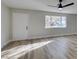 Living room with wood-look floors, window, and door at 647 Greenbriar Townhouse Way, Las Vegas, NV 89121