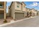 Row of modern townhouses with attached garages at 6867 Evening Orchid St, North Las Vegas, NV 89086