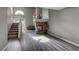 Spacious living room with a stone fireplace and grey wood-look flooring at 7929 Tulum Ct, Las Vegas, NV 89145