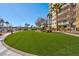 Landscaped grassy area with a walkway and building view at 8255 Las Vegas Blvd # 504, Las Vegas, NV 89123