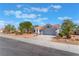 Single story home with a red tile roof and desert landscaping at 8800 Sundial Dr, Las Vegas, NV 89134