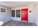 Inviting front entrance with a red door and two windows at 8800 Sundial Dr, Las Vegas, NV 89134