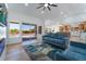 Spacious living room with blue sofas, electric fireplace, and sliding glass doors at 8800 Sundial Dr, Las Vegas, NV 89134