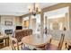 Open dining room with a view of the living room and fireplace, showcasing a spacious layout at 9520 Twelve Pins Dr, Las Vegas, NV 89129