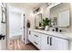 Modern bathroom with double vanity, white cabinets, and black matte fixtures at 9705 Standard Ave, Las Vegas, NV 89129