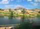 Scenic view of community lake, landscaping, and mountain backdrop at 10013 Cresent Creek Dr, Las Vegas, NV 89134