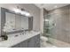 Modern bathroom with gray vanity, marble countertop, and a glass shower at 10543 San Palatina St, Las Vegas, NV 89141