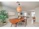 Bright dining room with mid-century modern table and light fixture at 11016 Rossi Ave, Las Vegas, NV 89144