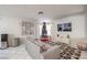 Living area with gray couch and geometric patterned rug at 11016 Rossi Ave, Las Vegas, NV 89144