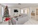 Living room with gray couch, Christmas tree, and tile floors at 11016 Rossi Ave, Las Vegas, NV 89144