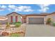 Single-story house with a two-car garage and landscaped front yard at 2210 Bensley St, Henderson, NV 89044