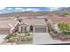 Single story house with grey garage door and landscaping at 2210 Bensley St, Henderson, NV 89044