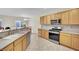 Kitchen with stainless steel appliances and light wood cabinets at 2210 Bensley St, Henderson, NV 89044