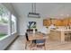 Modern dining room with a wood table and light-colored cabinets at 2259 Galindo Ct, Henderson, NV 89052