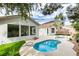 Relaxing kidney shaped pool and spa with a view of the home's sunroom at 2259 Galindo Ct, Henderson, NV 89052