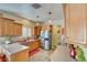 L-shaped kitchen with stainless steel appliances and wood cabinets at 4890 Willis St, North Las Vegas, NV 89031