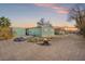 Backyard view at sunset with a fire pit and large yard at 509 Kings Ave, North Las Vegas, NV 89030