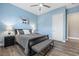 Light blue bedroom with a comfortable bed and wood floors at 5523 Taylor Rose Ave, Las Vegas, NV 89139