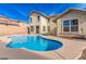 Inviting kidney-shaped pool in backyard oasis at 5861 Lakeland Village Dr, North Las Vegas, NV 89081