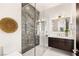 Modern bathroom with glass shower, marble tile, and sleek vanity at 661 Ridgestone Rim Ct, Henderson, NV 89012