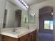 Double vanity bathroom with large mirror and access to bedroom at 6624 Lavender Lilly Ln # 1, North Las Vegas, NV 89084