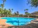 Inviting community pool with palm trees and clear blue water at 6624 Lavender Lilly Ln # 1, North Las Vegas, NV 89084